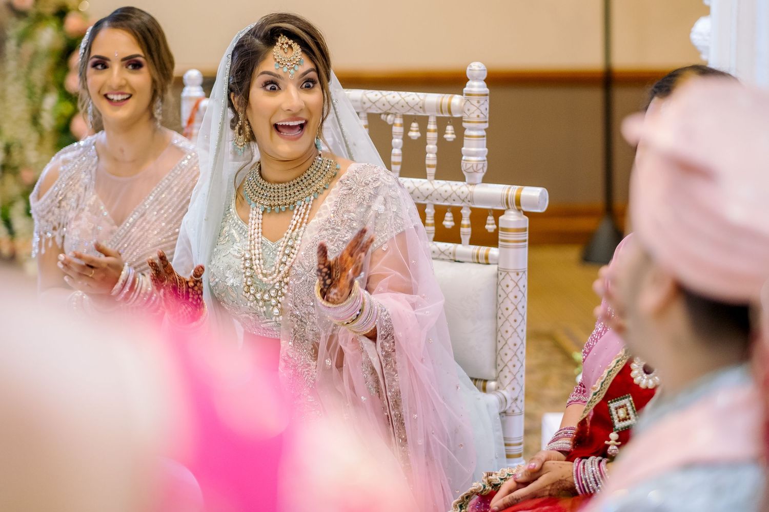 Wedding celebration scene with guests seated at decorated tables.