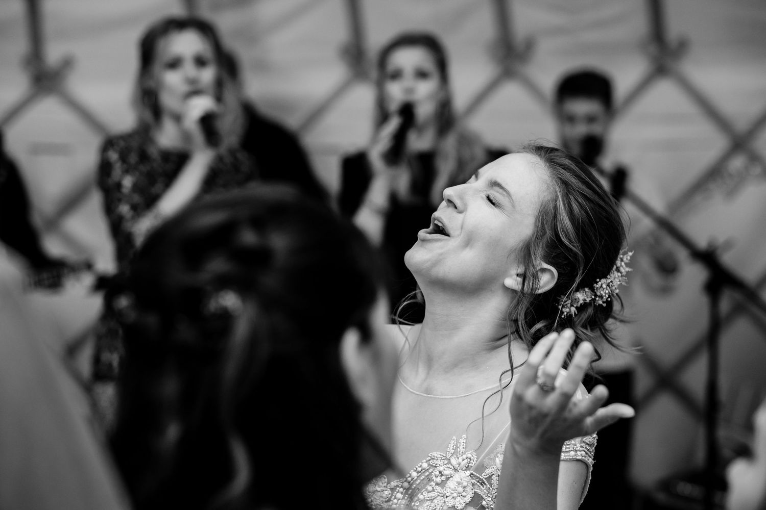 Black and white candid shots of joyful moments during a wedding celebration.
