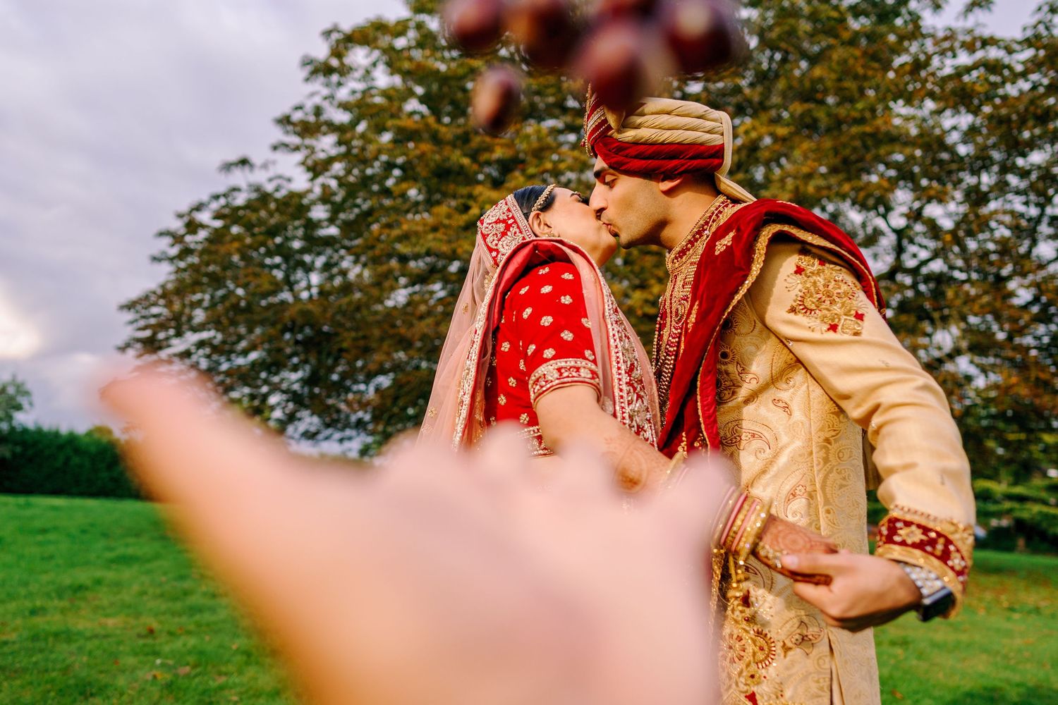 Outdoor wedding photography session with autumn trees and natural lighting.