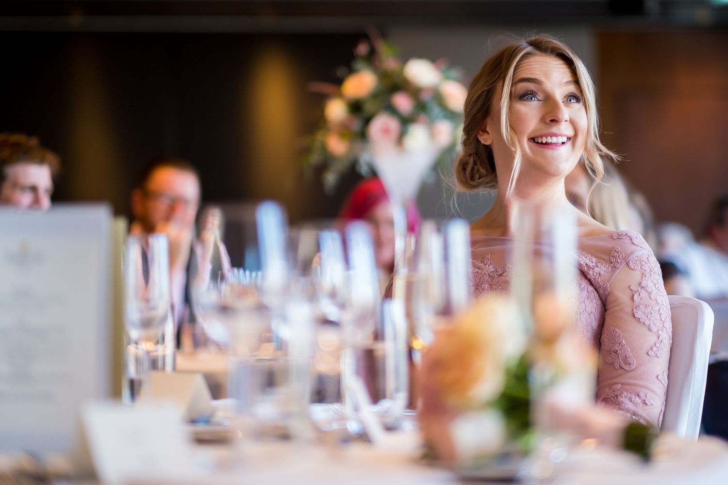 Close-up of elegant place settings with wine glasses at a wedding reception.