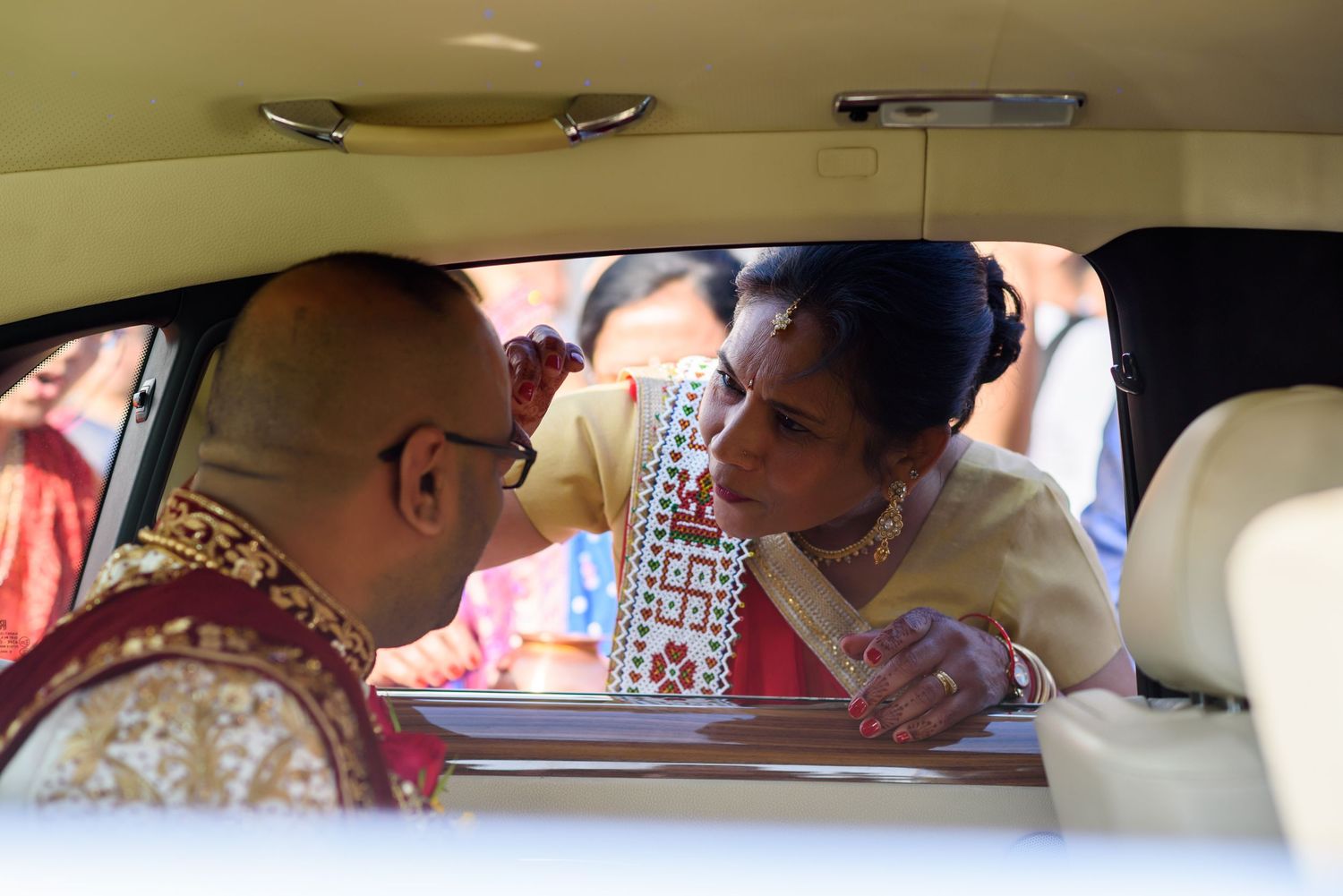 A panoramic view inside a car shows multiple passengers seated across the back seats.
