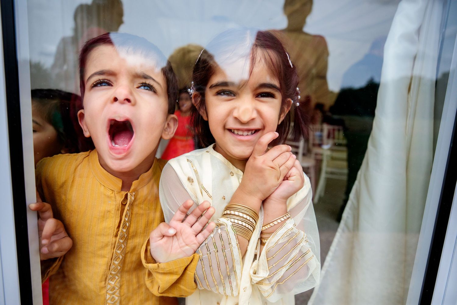 Children playing and laughing together during a wedding celebration.