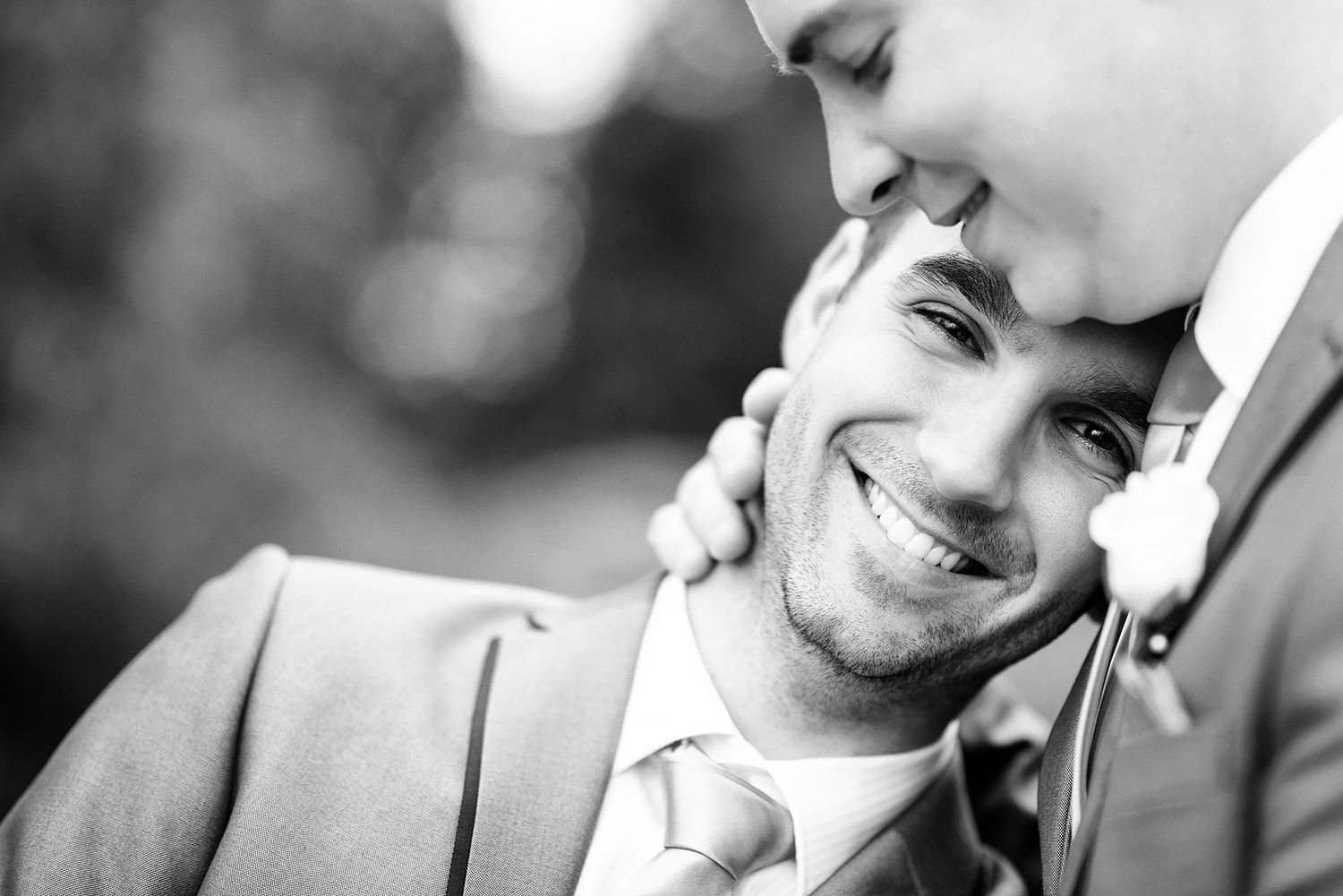 Intimate black and white wedding portraits showing joyful expressions.