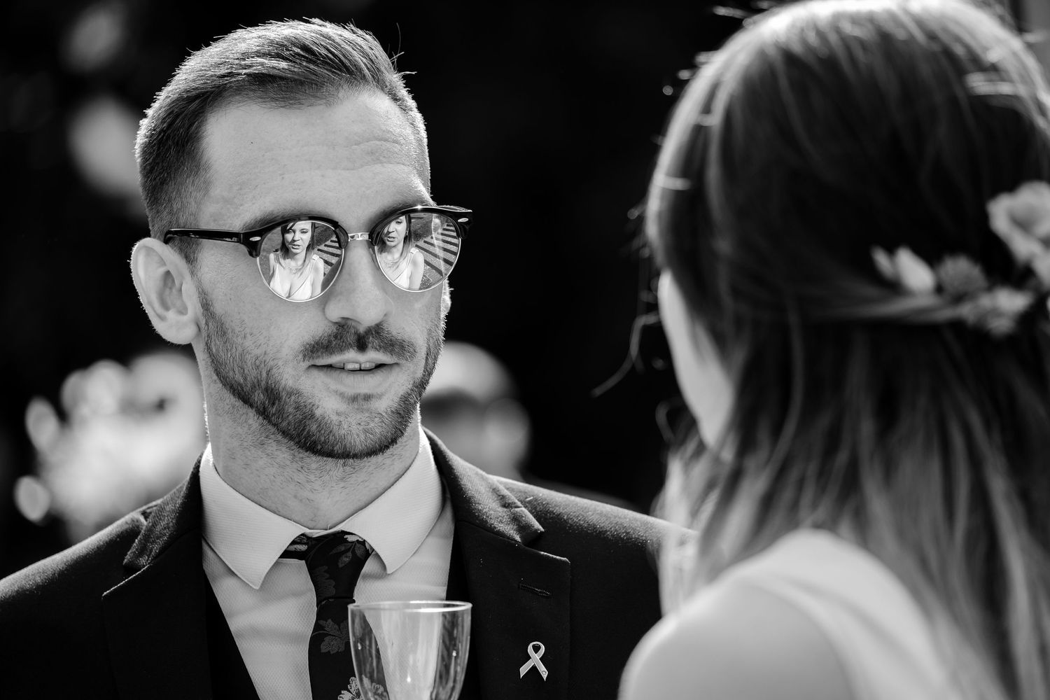 Close-up moment during an intimate wedding reception conversation.