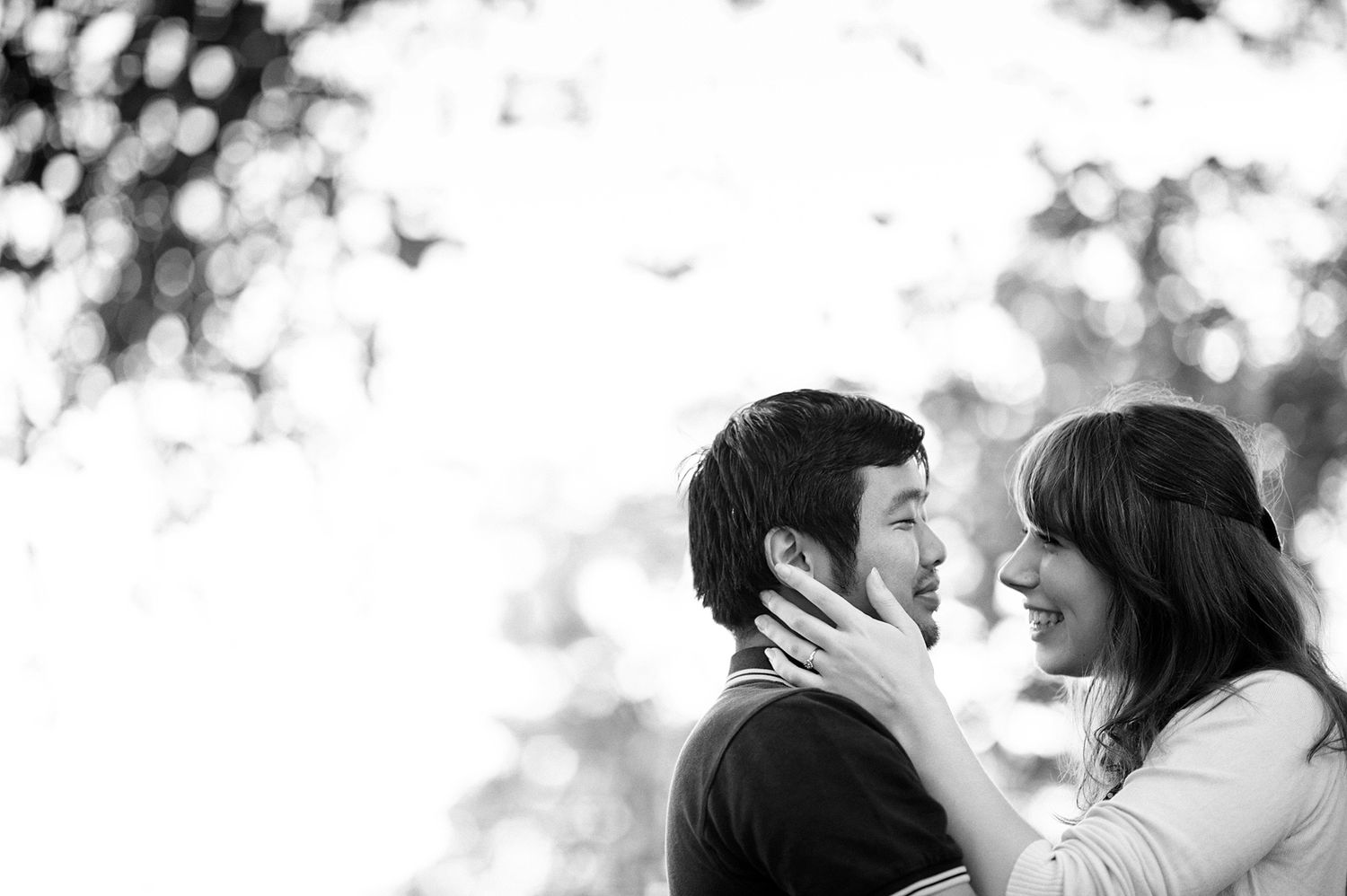 Black and white close-up of a couple sharing an intimate moment.