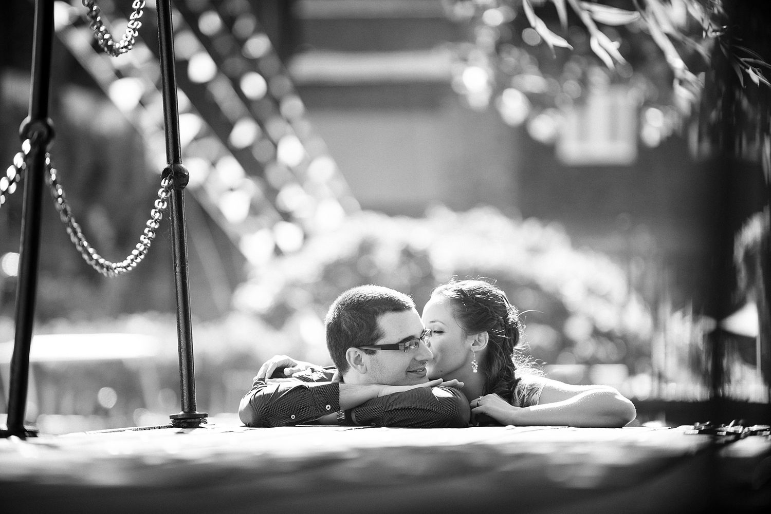 Romantic black and white portrait with bokeh lights in background.