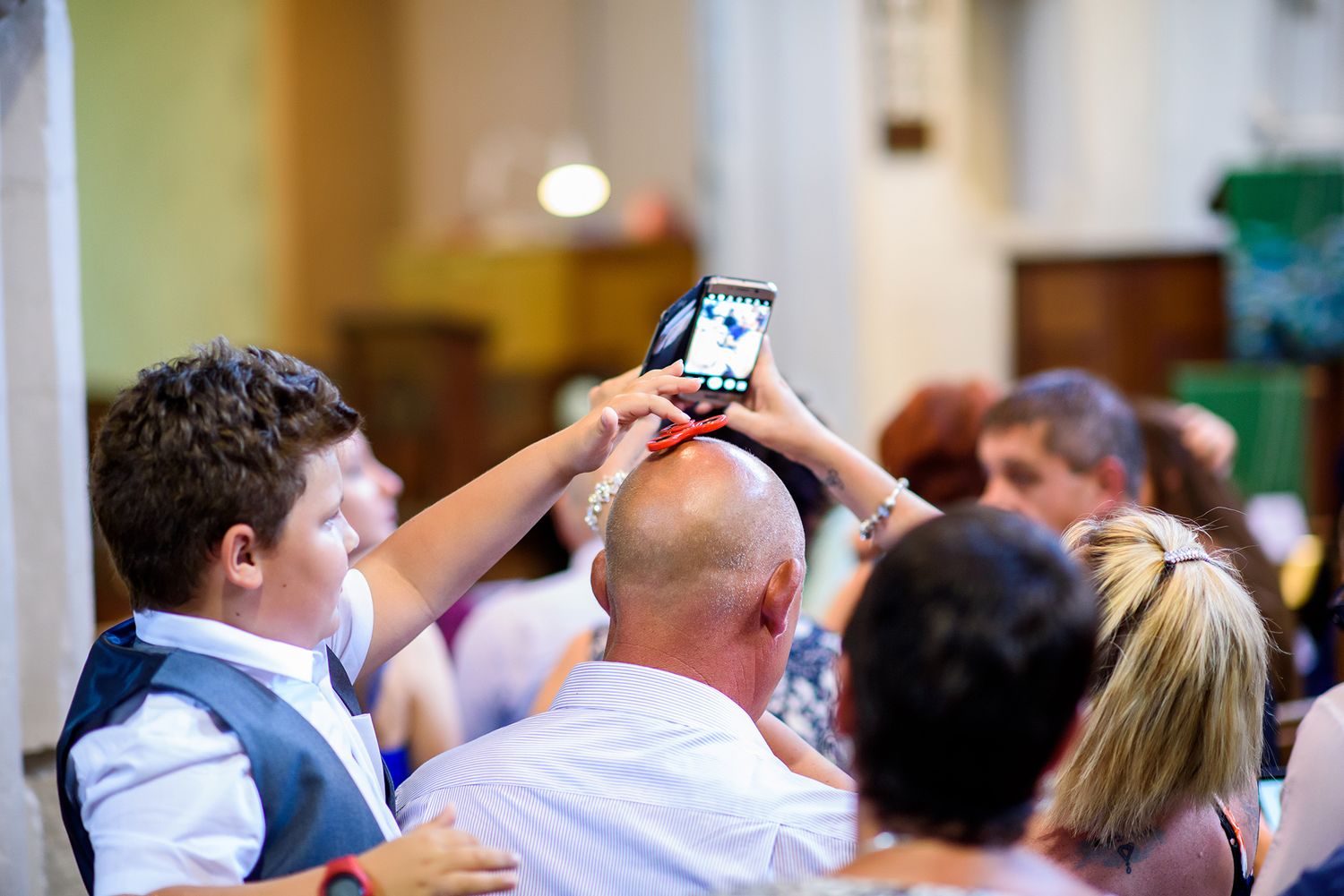 Wedding guests raising their glasses during a celebratory toast at a reception.