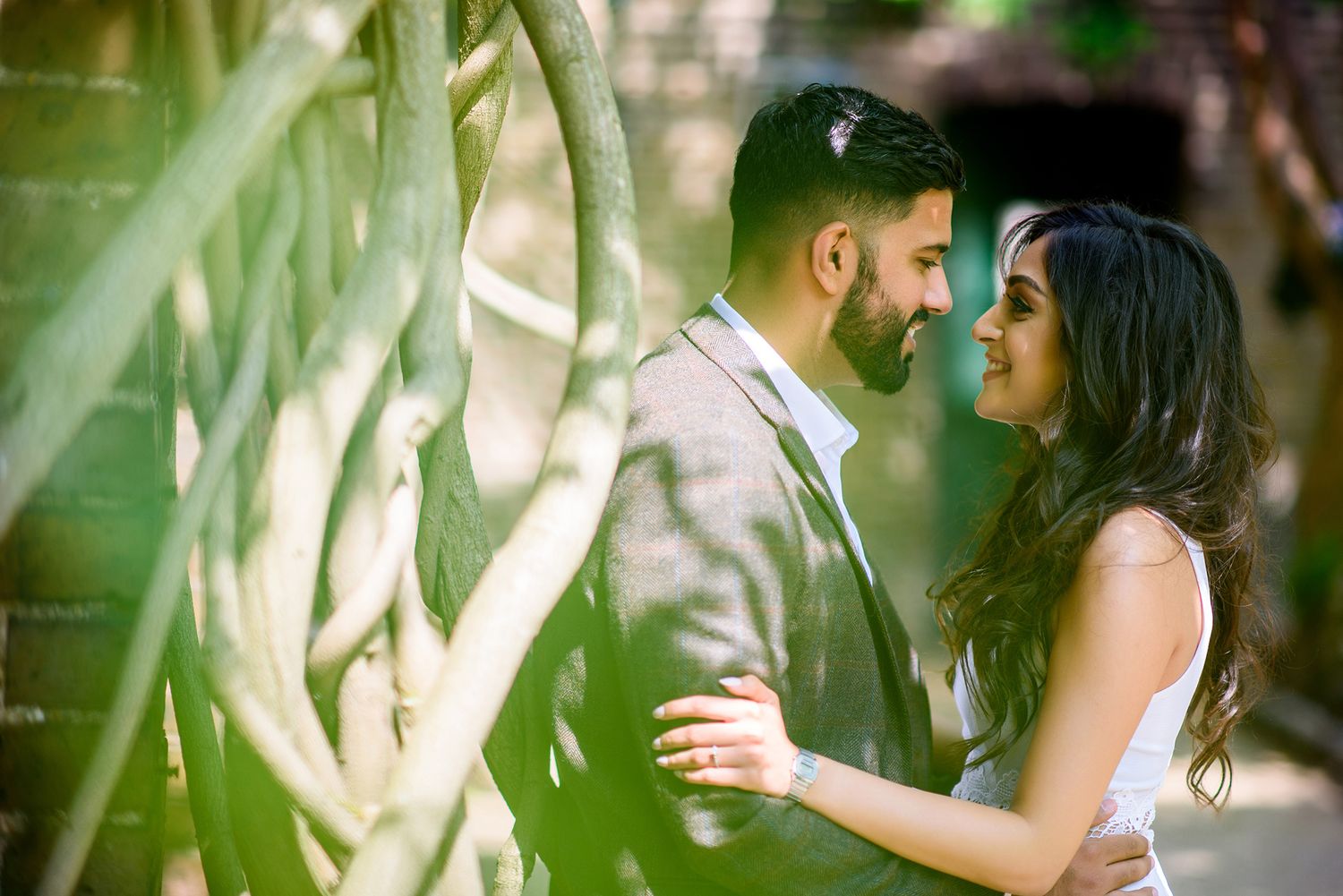 Romantic garden photoshoot with soft bokeh and natural foliage framing.