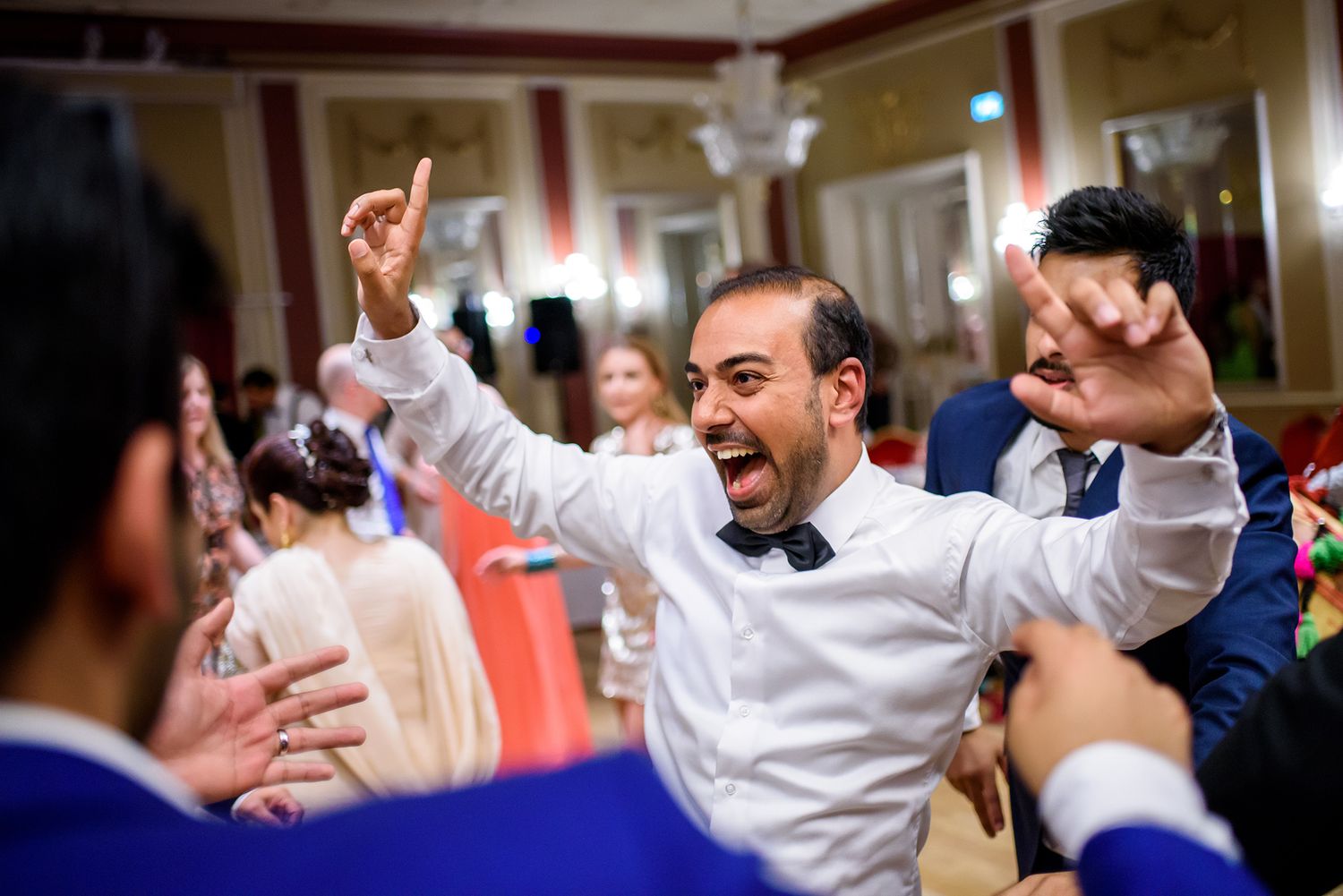 Energetic dance celebration in progress with guests enjoying festivities on dance floor.