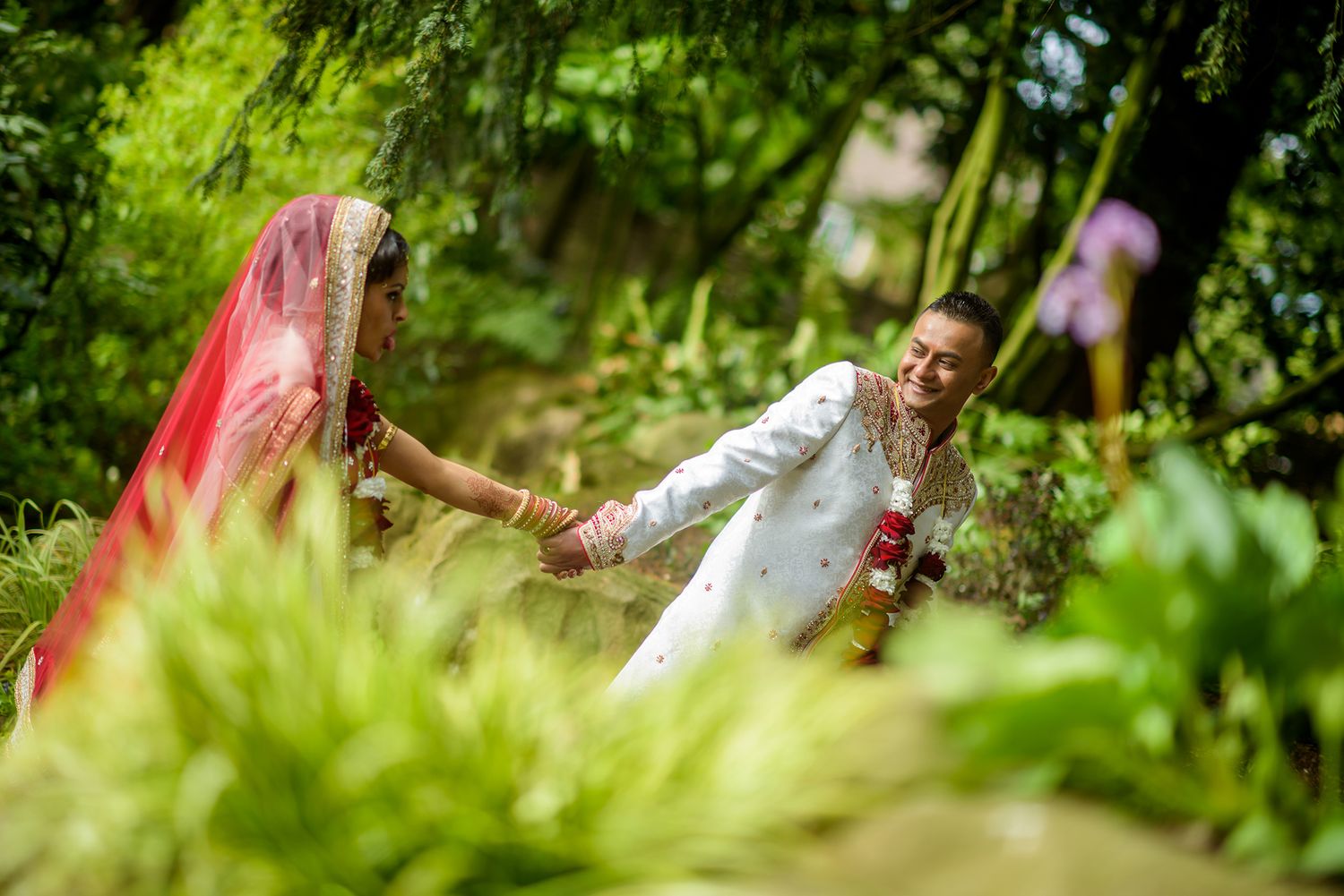 Natural garden wedding photography with green foliage and soft lighting.