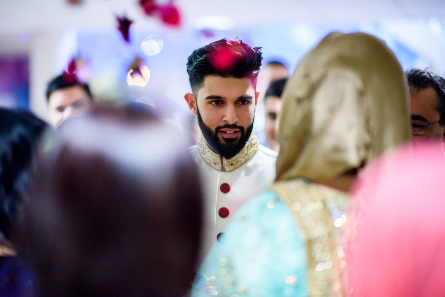 Traditional Indian wedding ceremony with elegant decor and guests in formal attire.