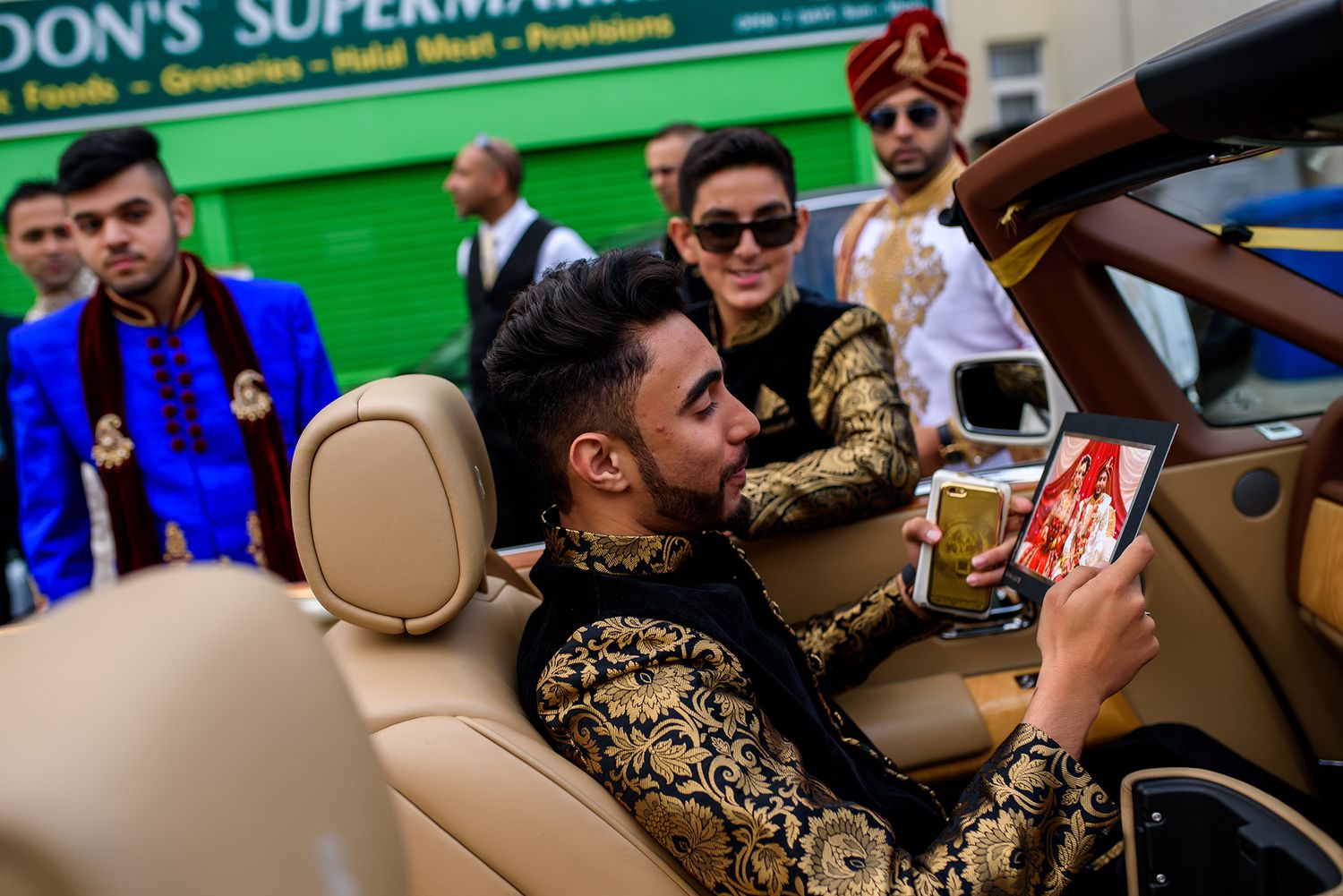 Wedding party gathers outside Don's Supermarket during celebration festivities.