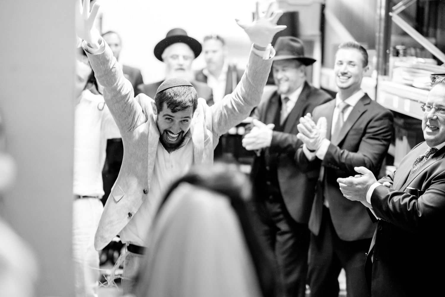 Black and white photo sequence capturing celebratory moments at a wedding reception.
