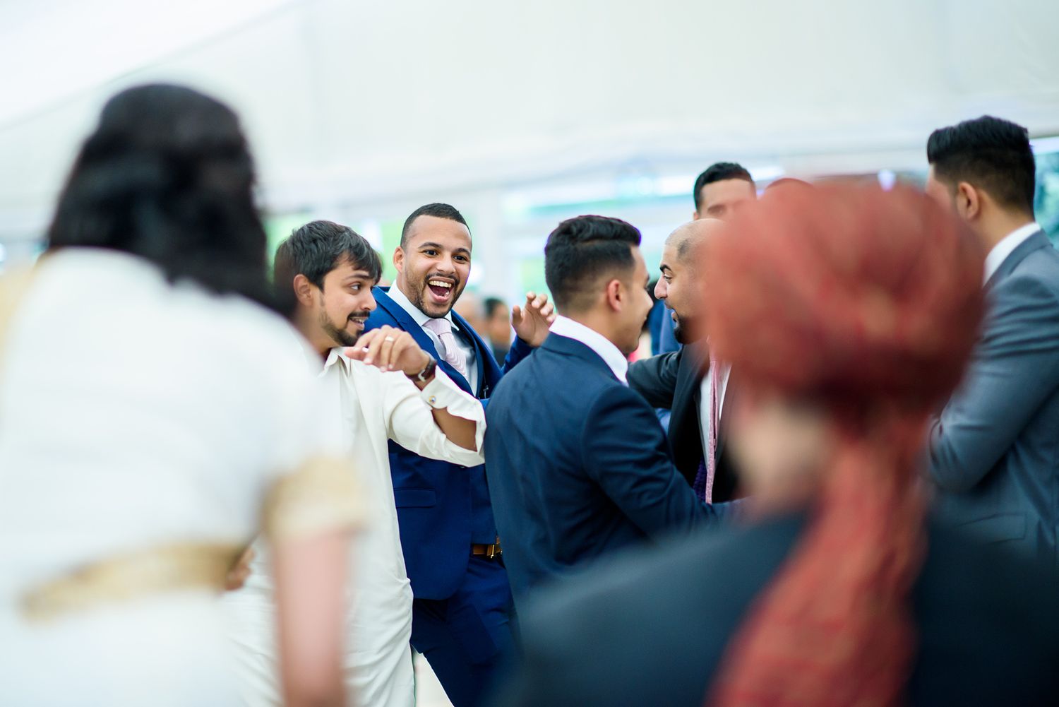 Guests interacting during a festive outdoor wedding reception.