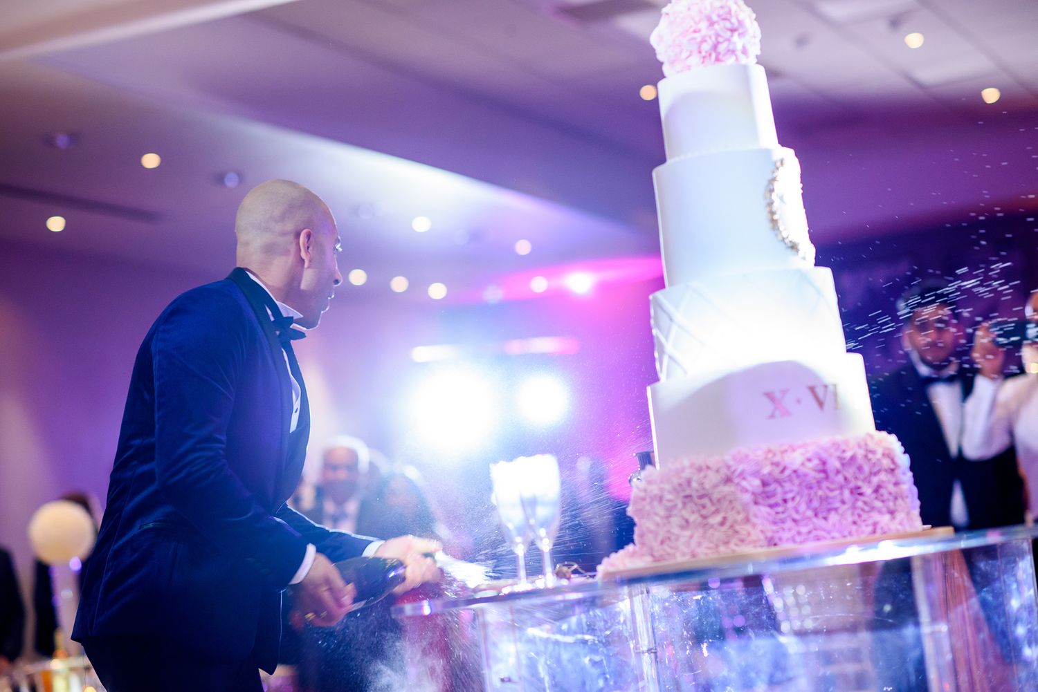 Close-up view of champagne pouring and bubbling at an elegant wedding reception celebration.