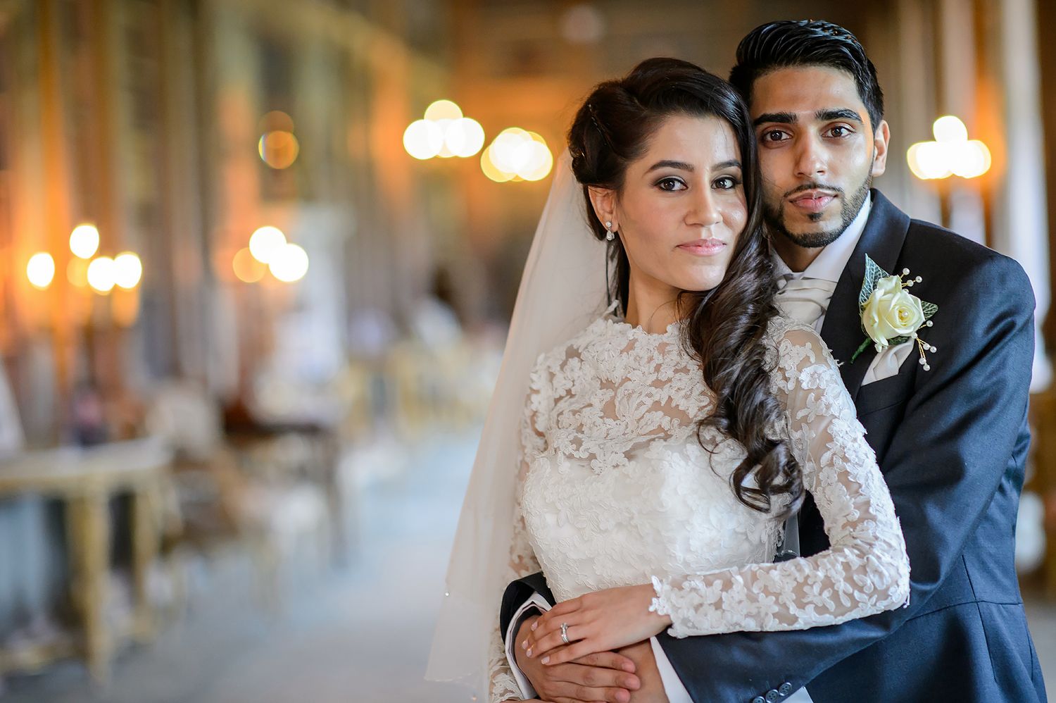 Wedding couple and party portraits in an elegant venue with classical architecture.