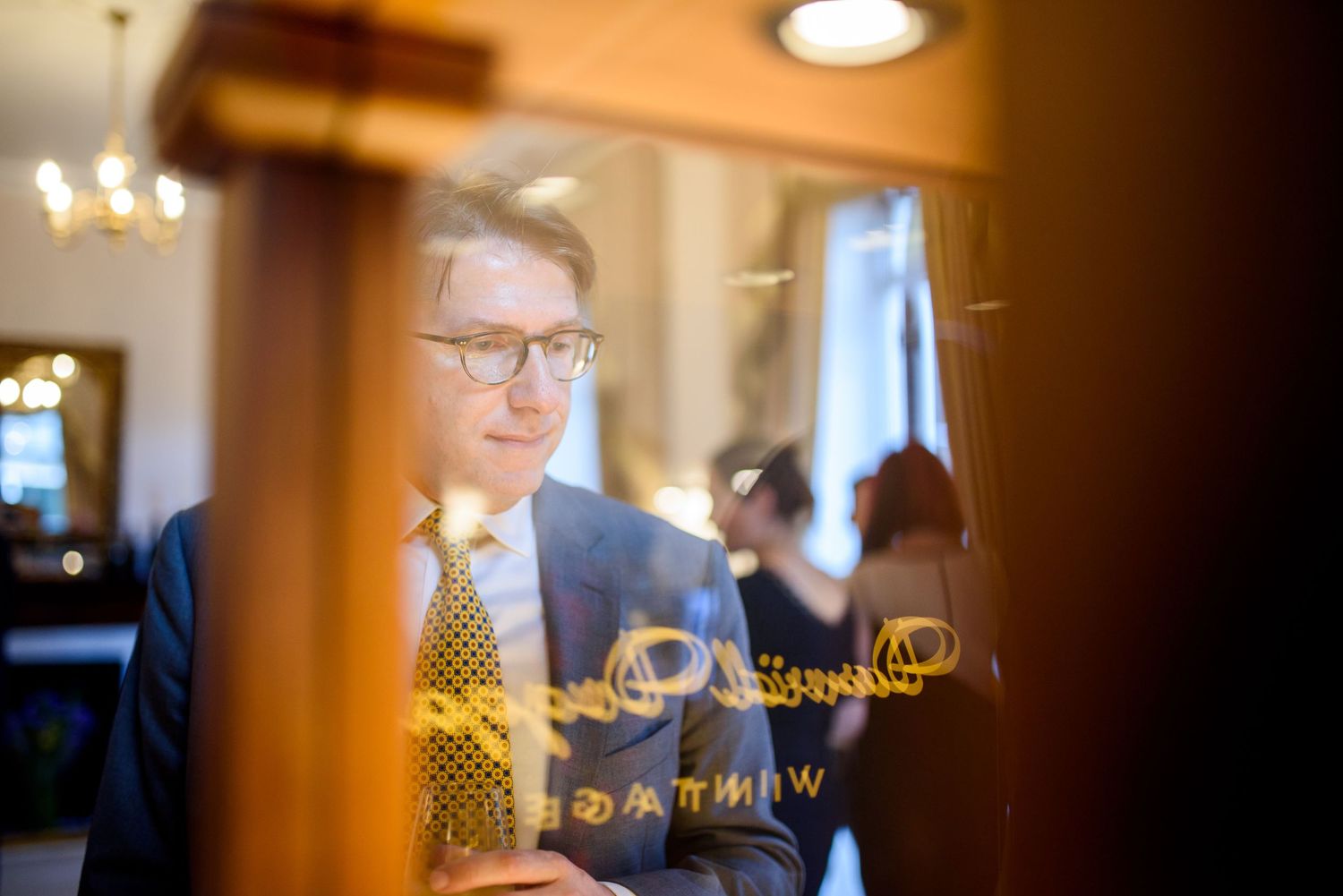Warm-toned interior shots of business meeting through creative framing.