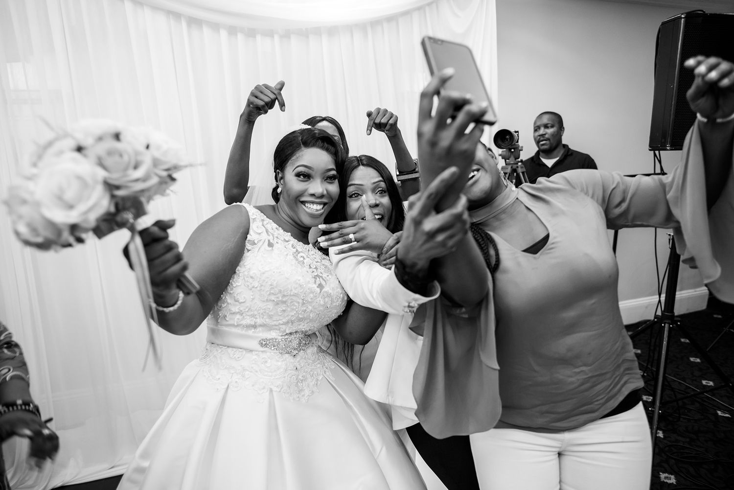 Dancing and celebrating at an elegant wedding reception in black and white.