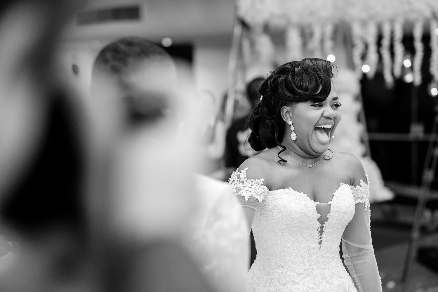 A candid dance celebration scene with guests in formal attire at an elegant venue.