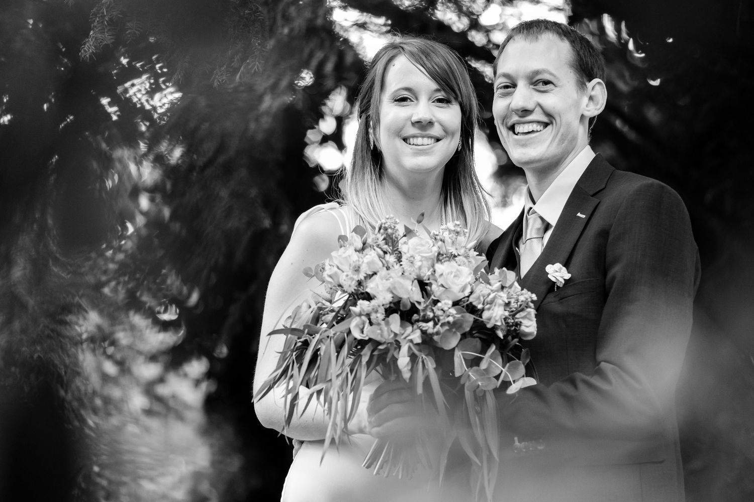 Black and white romantic wedding portrait in natural outdoor setting.