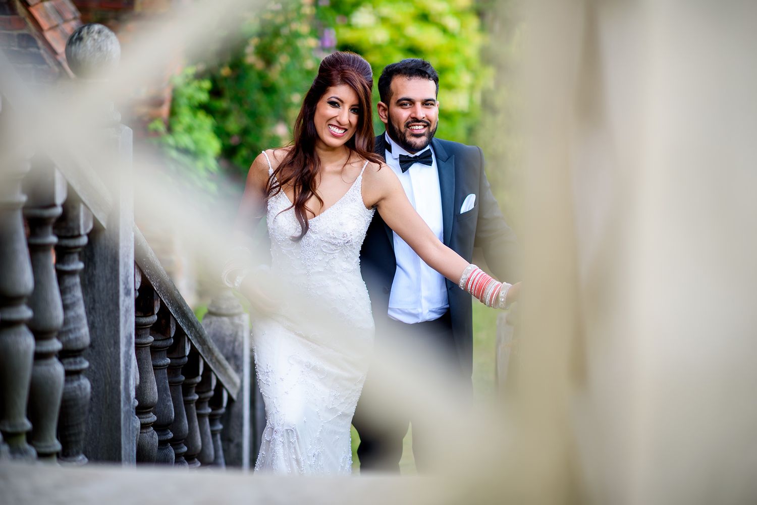 Romantic wedding portrait captured through decorative architectural elements.