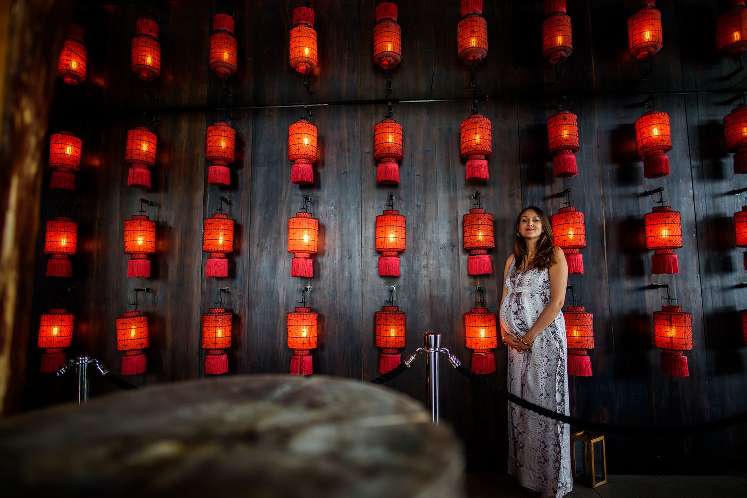 Long wall of traditional red lanterns creates dramatic lighting effect.
