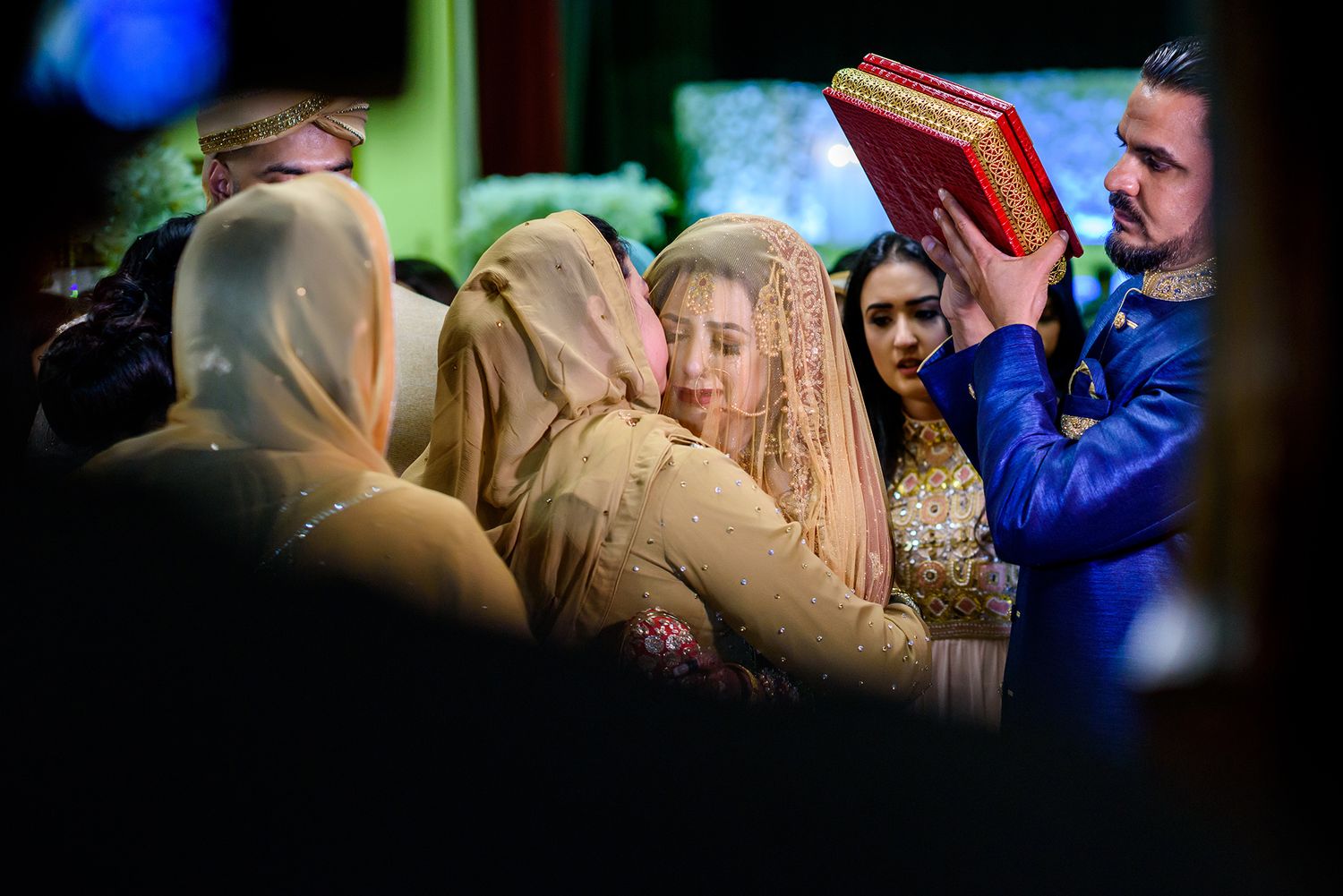 Colorful crowd scene at a cultural celebration with blue and gold tones.