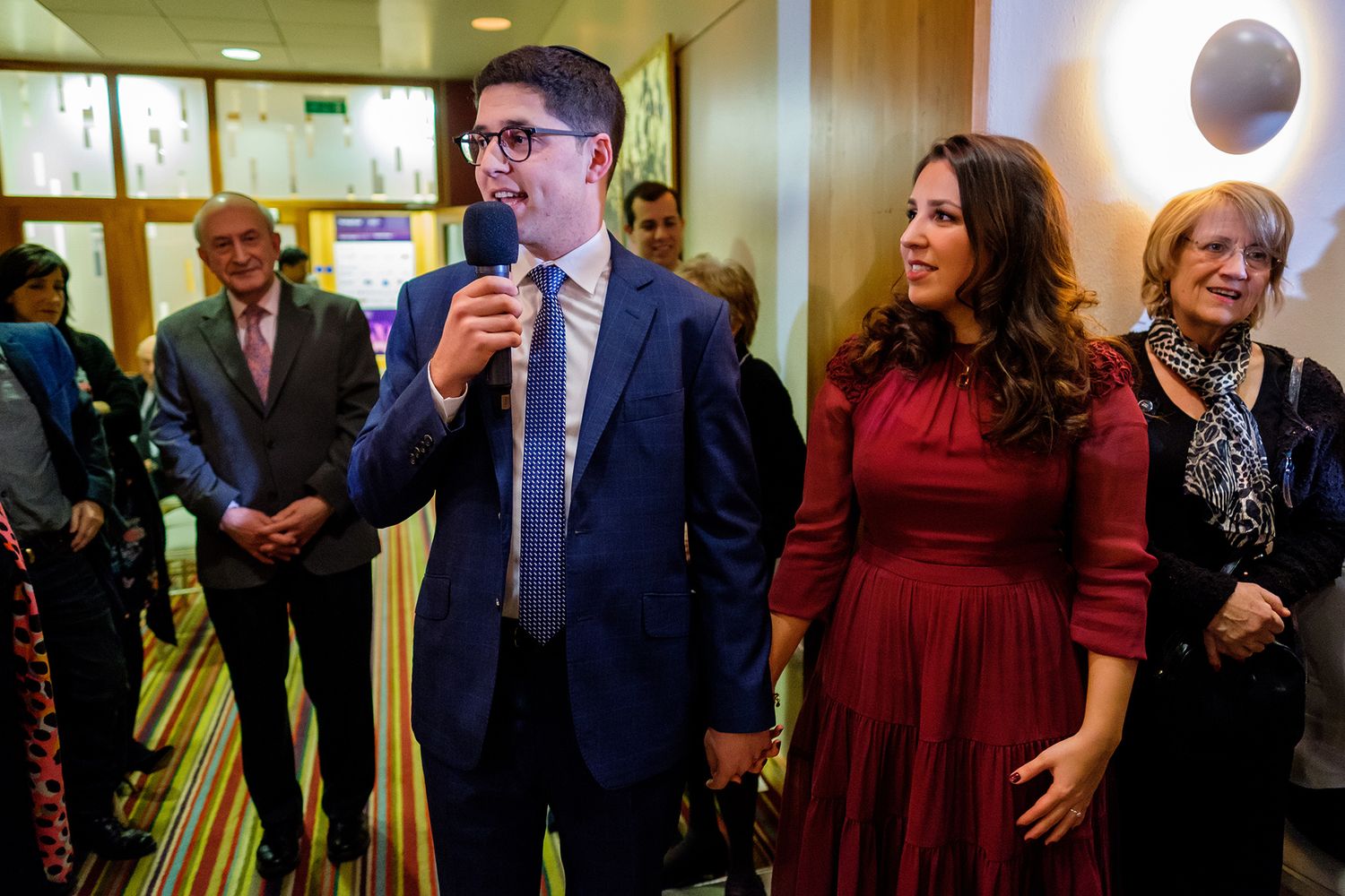 Joyful wedding reception guests celebrating and dancing together in an elegant venue.