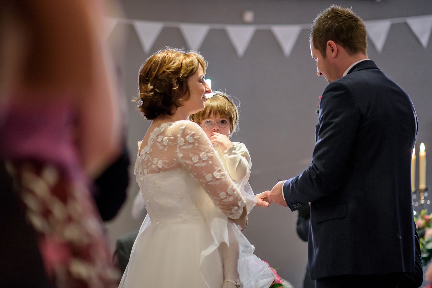 Wedding reception celebration with white bunting decorations overhead.
