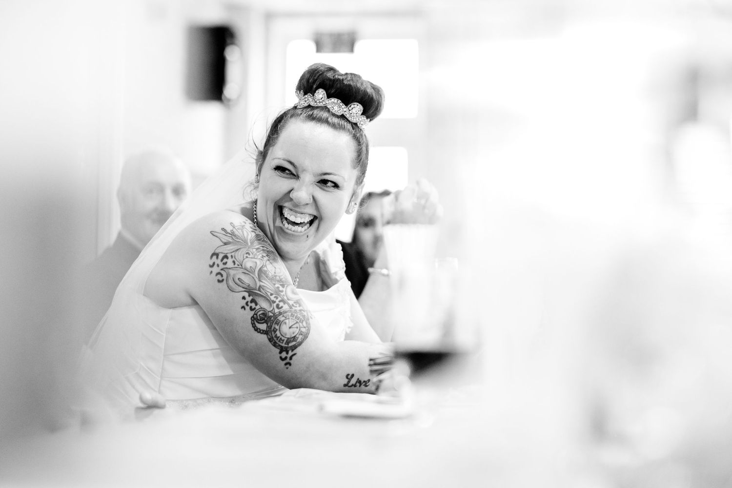 Black and white candid wedding photography showing joyful moments.