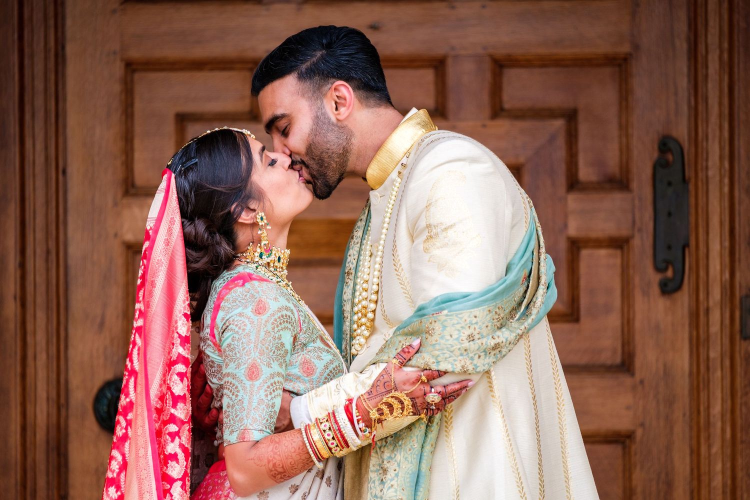 Traditional Indian wedding ceremony taking place in an elegant wood-paneled room.