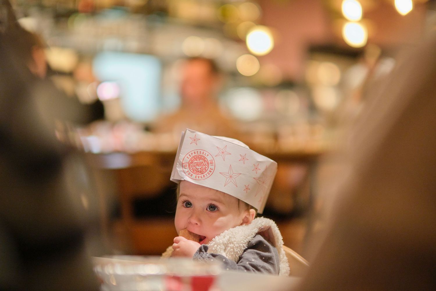 Warm ambient lighting creates a cozy atmosphere in restaurant dining space with bokeh effects.