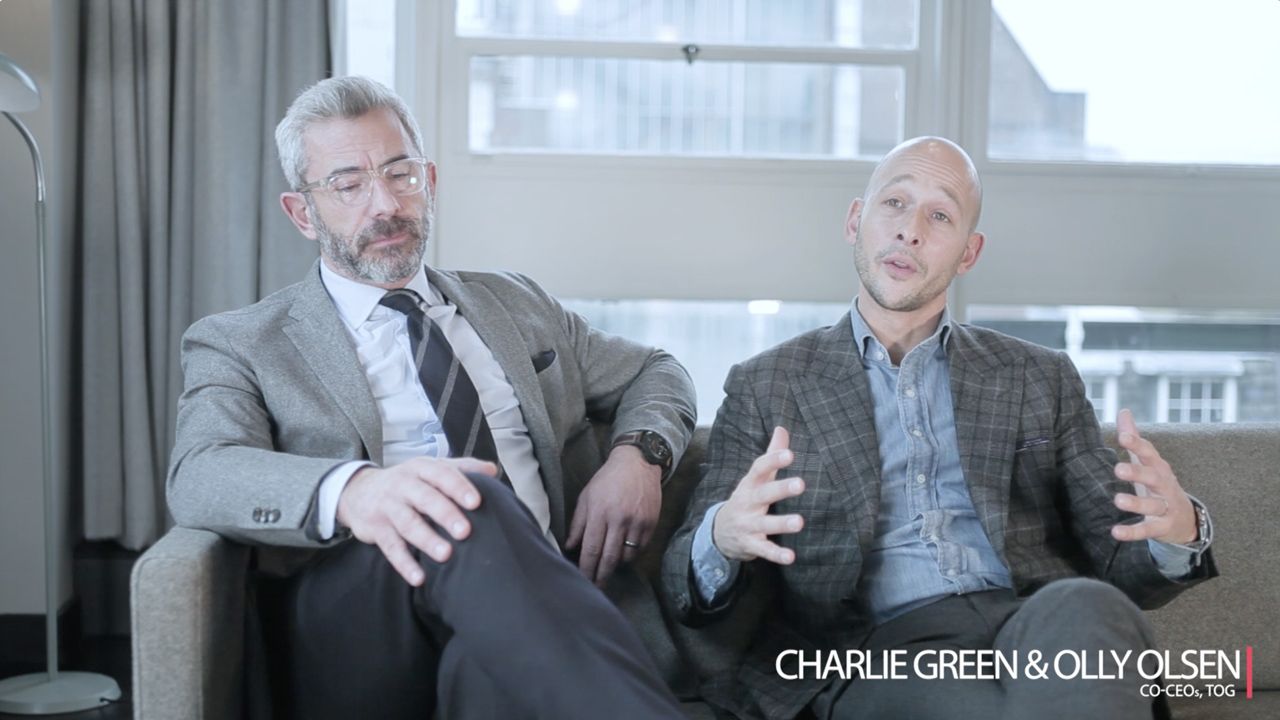Charlie Green and Olly Olsen sit together in a professional interview setting, engaged in conversation.
