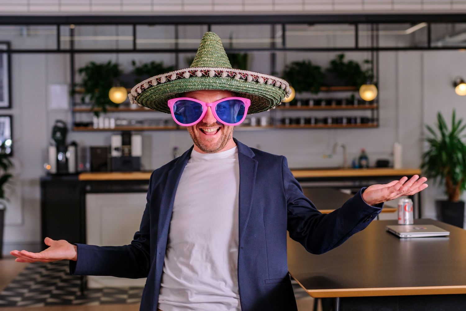 Person in business attire gestures while presenting in modern office setting.