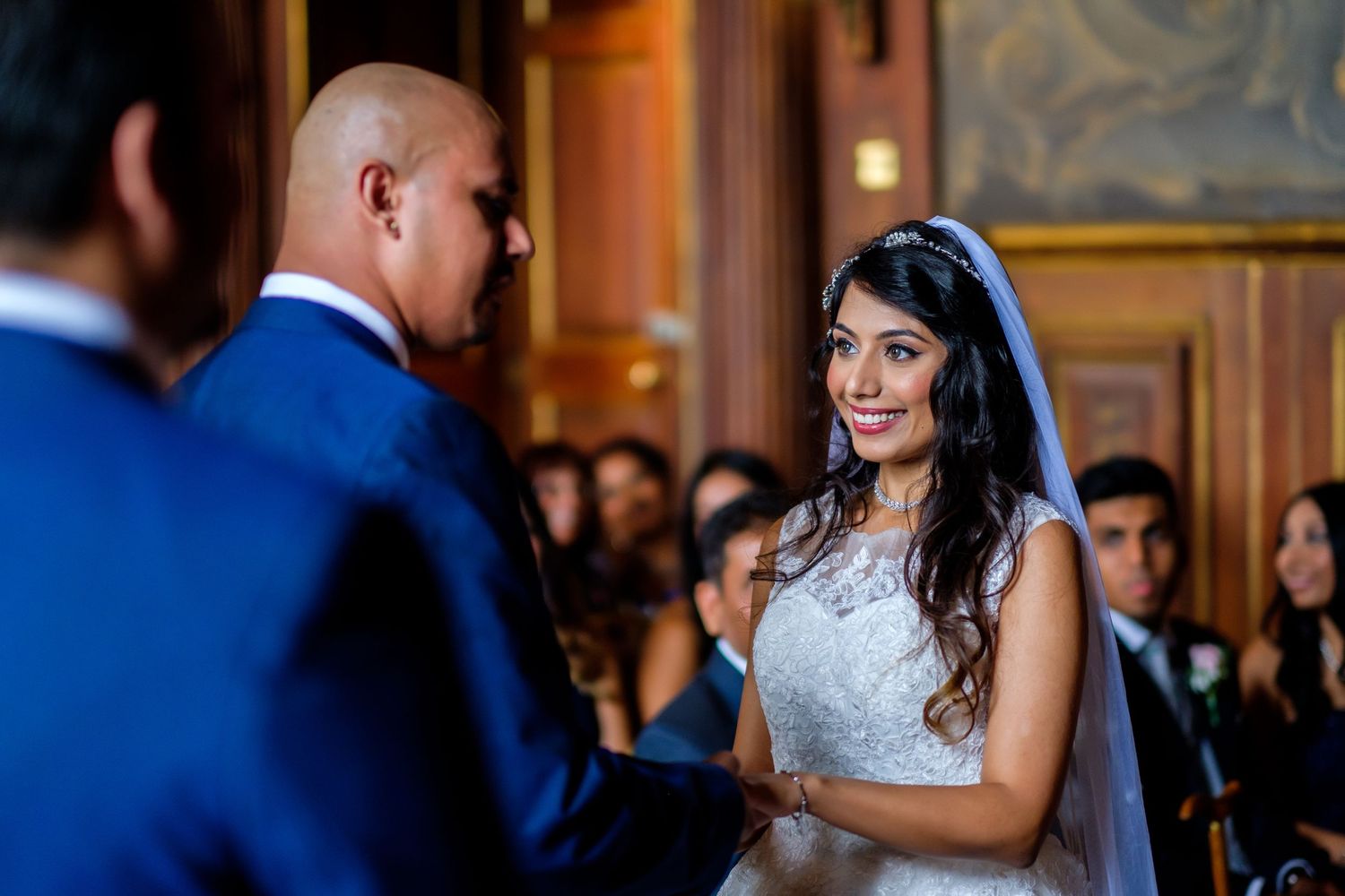 Wedding celebration inside an ornate ballroom with classic architectural details.
