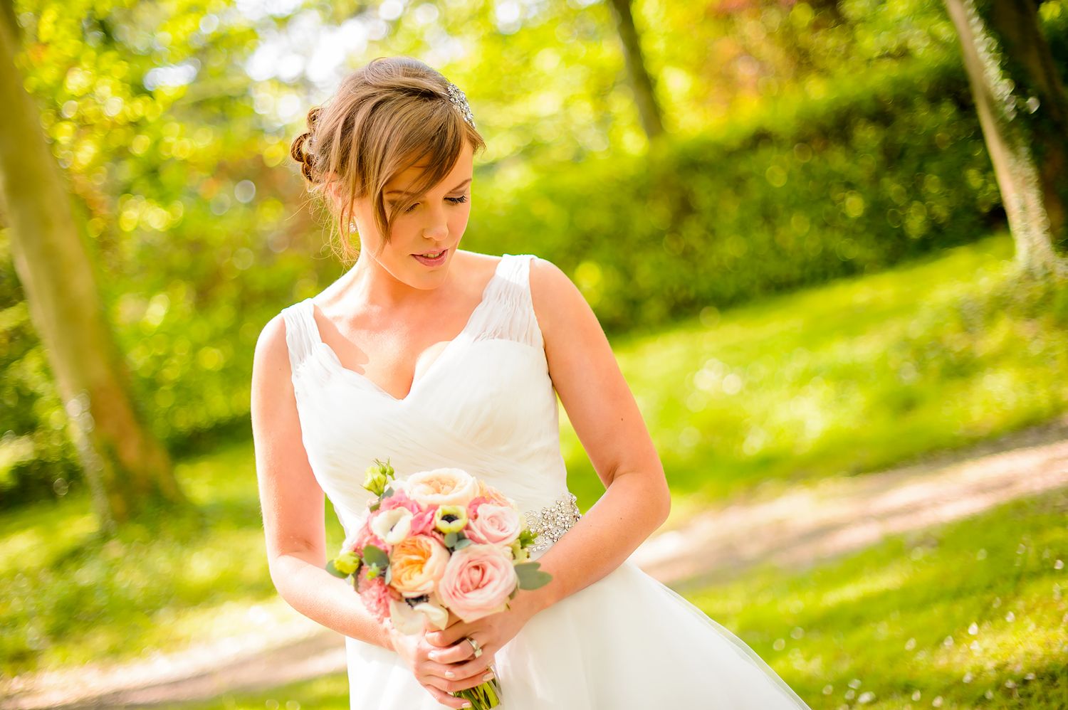 Several wedding photos showcasing elegant white dress and outdoor scenery.