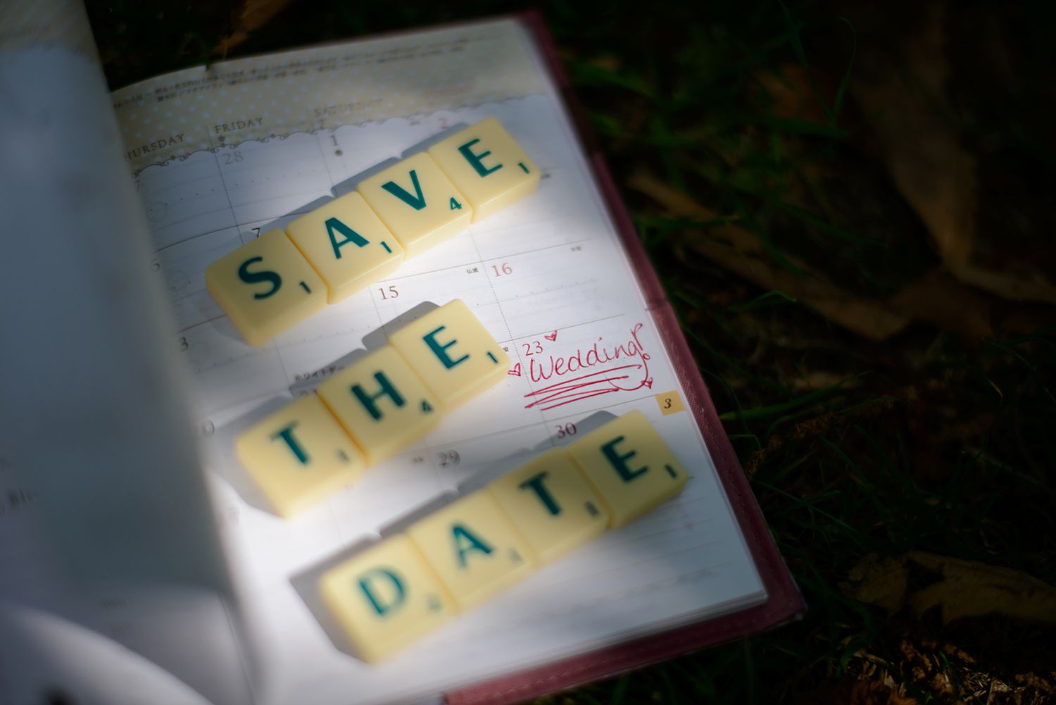Scrabble letter tiles spelling out a romantic message against a dark background.