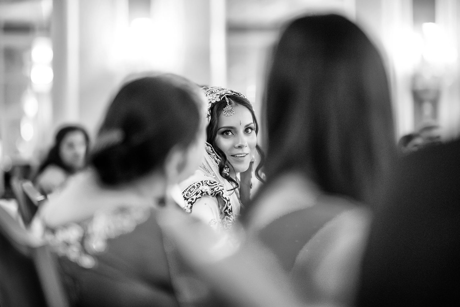 Black and white candid photograph of guests celebrating at formal event.