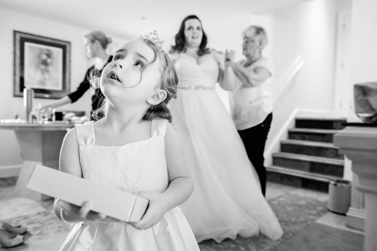 Black and white image of wedding preparations in a bright room.