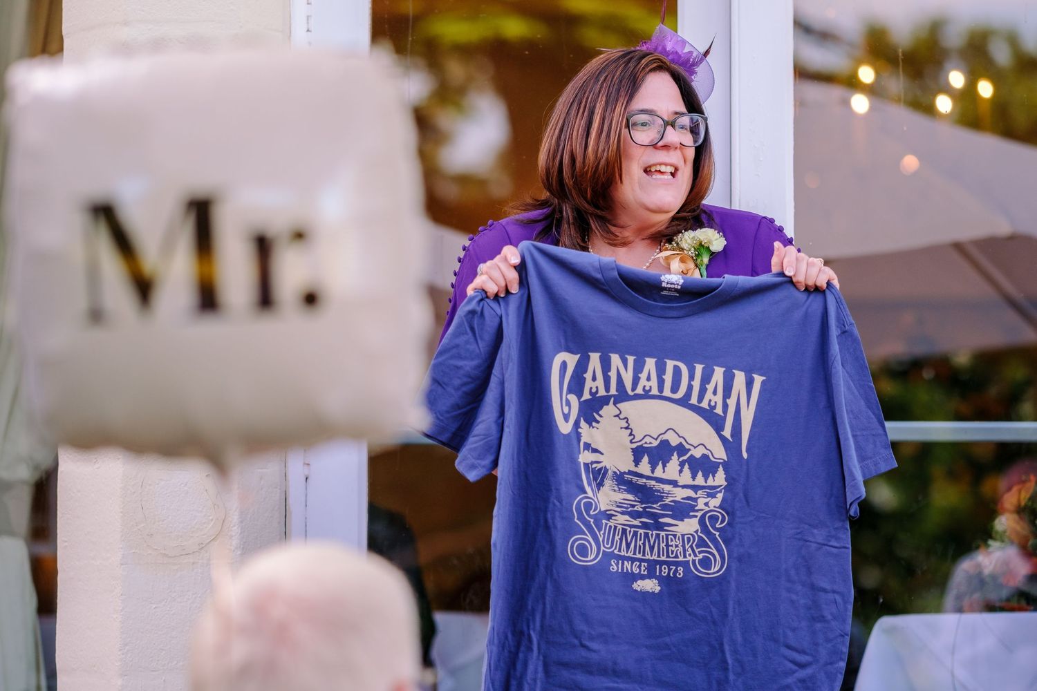 Several people wearing matching blue Canadian t-shirts standing together at an event.