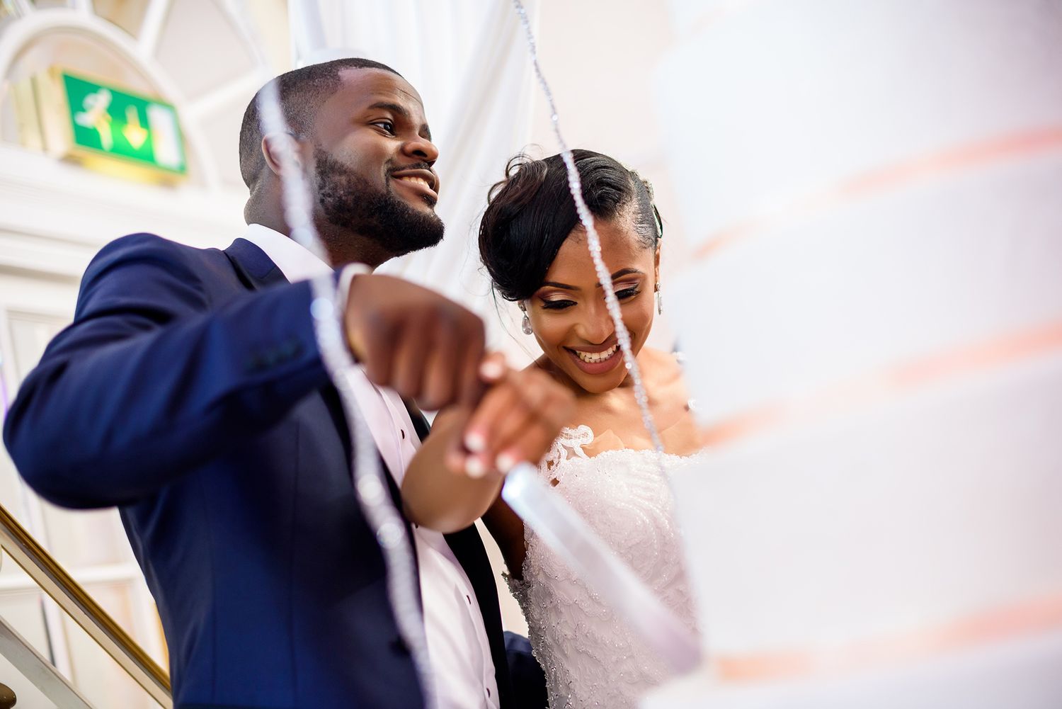 Couple dancing together with joyful expressions at their wedding celebration.