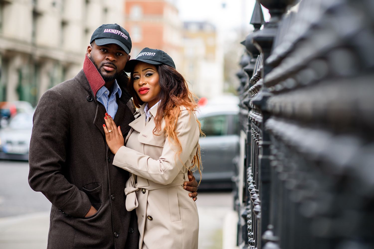 Stylish couple sharing a tender moment outdoors in urban environment.