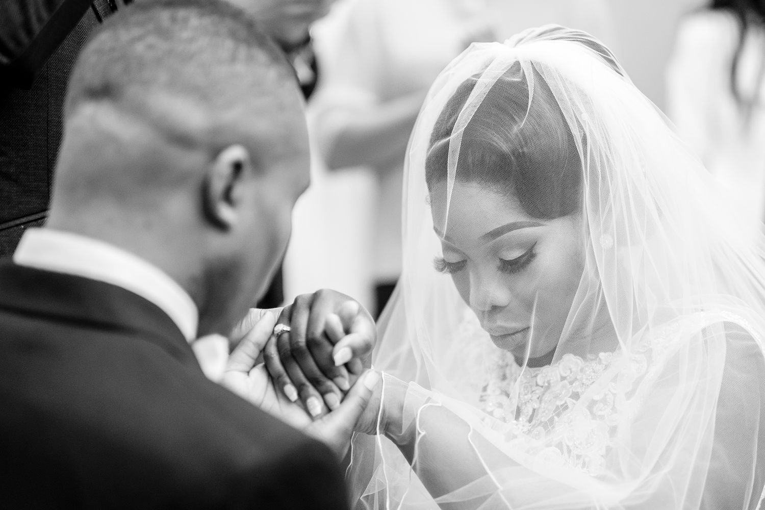 Intimate black and white portrait of a bride wearing a delicate veil.