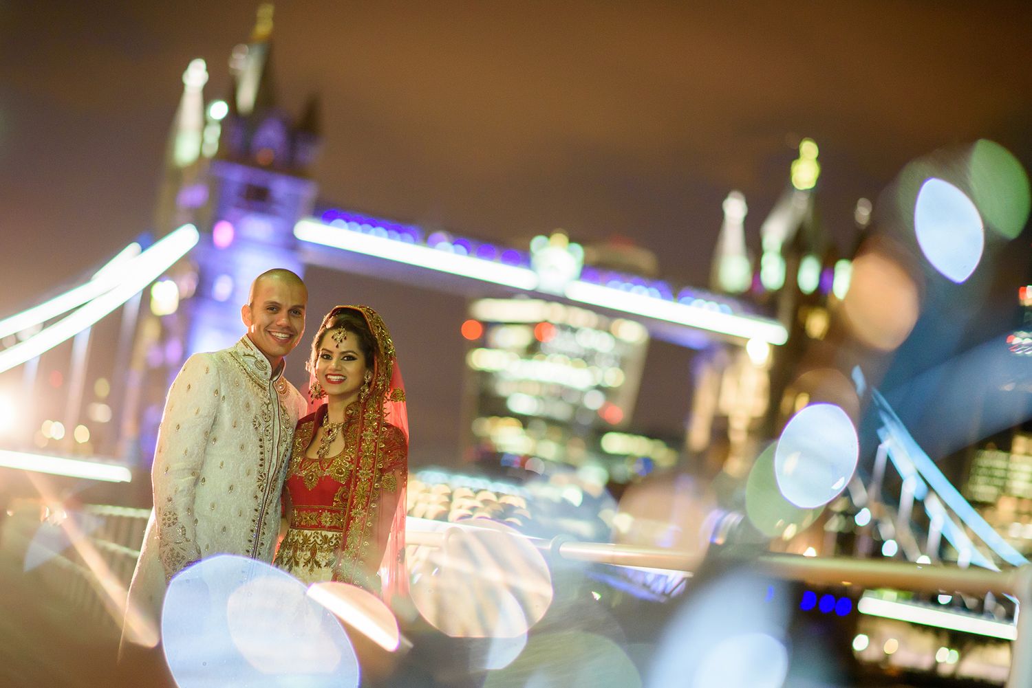 Bokeh lights create a dreamy nighttime ambiance with blurred city lights in the background.