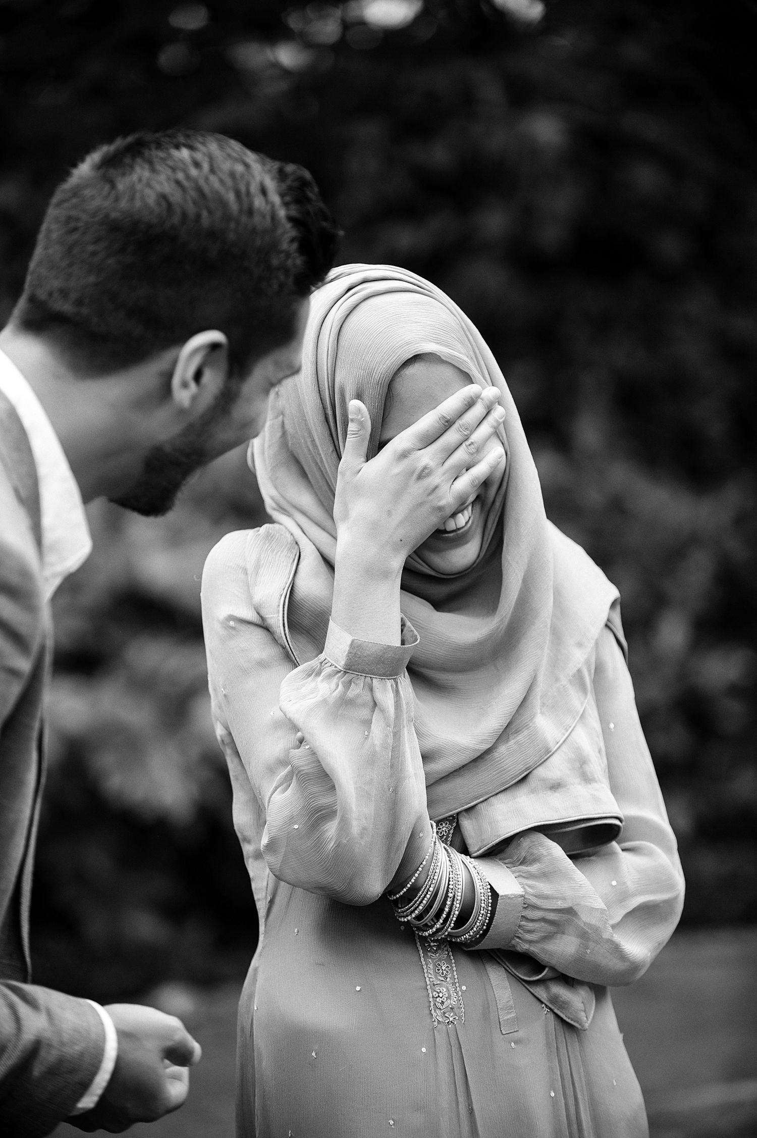 Black and white romantic candid moment captured in a garden.