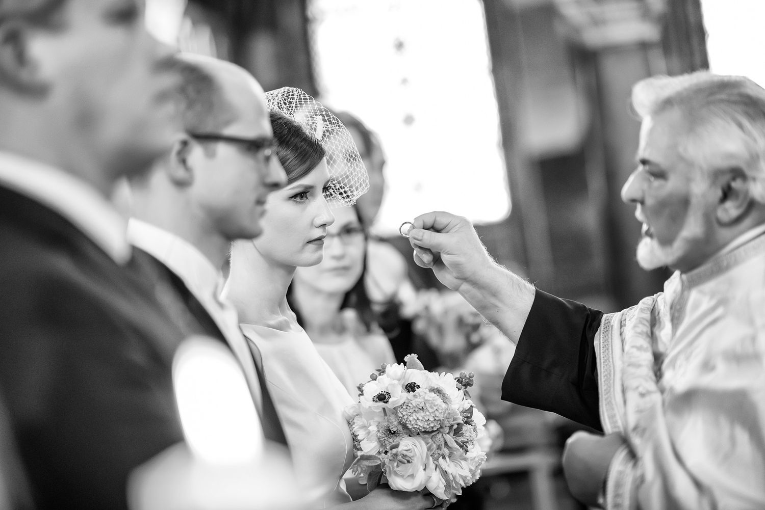 Wedding ceremony guests interacting during celebratory moments in black and white.