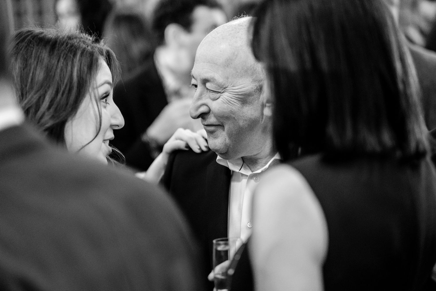 Black and white candid shots of people interacting at a social gathering.