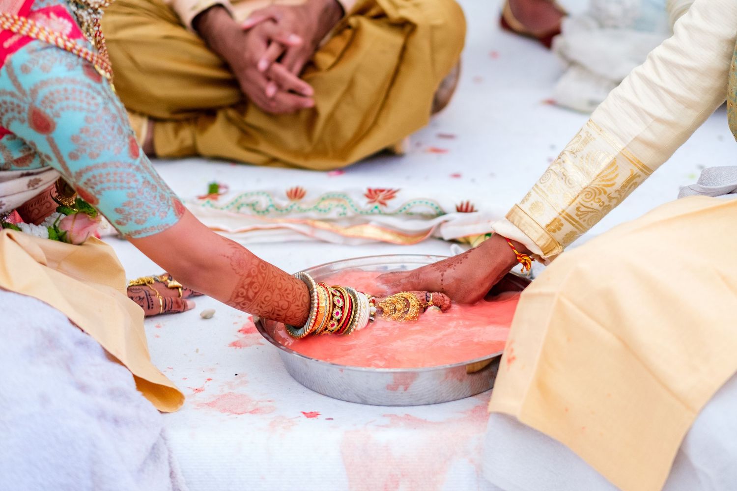 Traditional Indian wedding ceremony rituals with detailed henna and ceremonial items.
