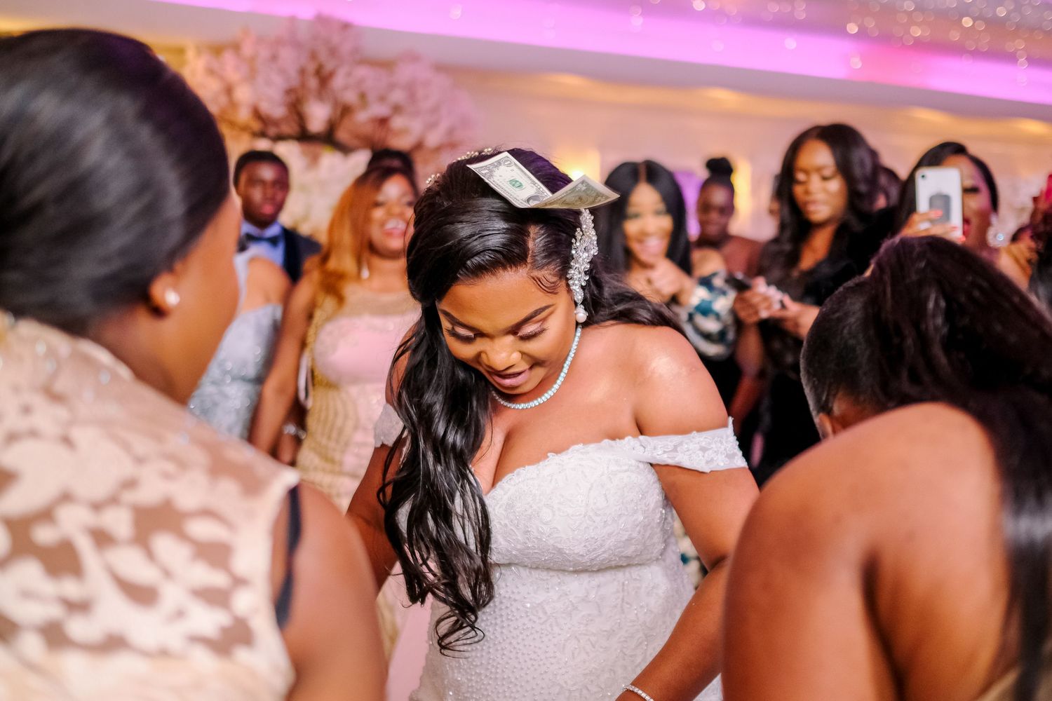 Wedding reception dance floor filled with guests celebrating in formal attire.