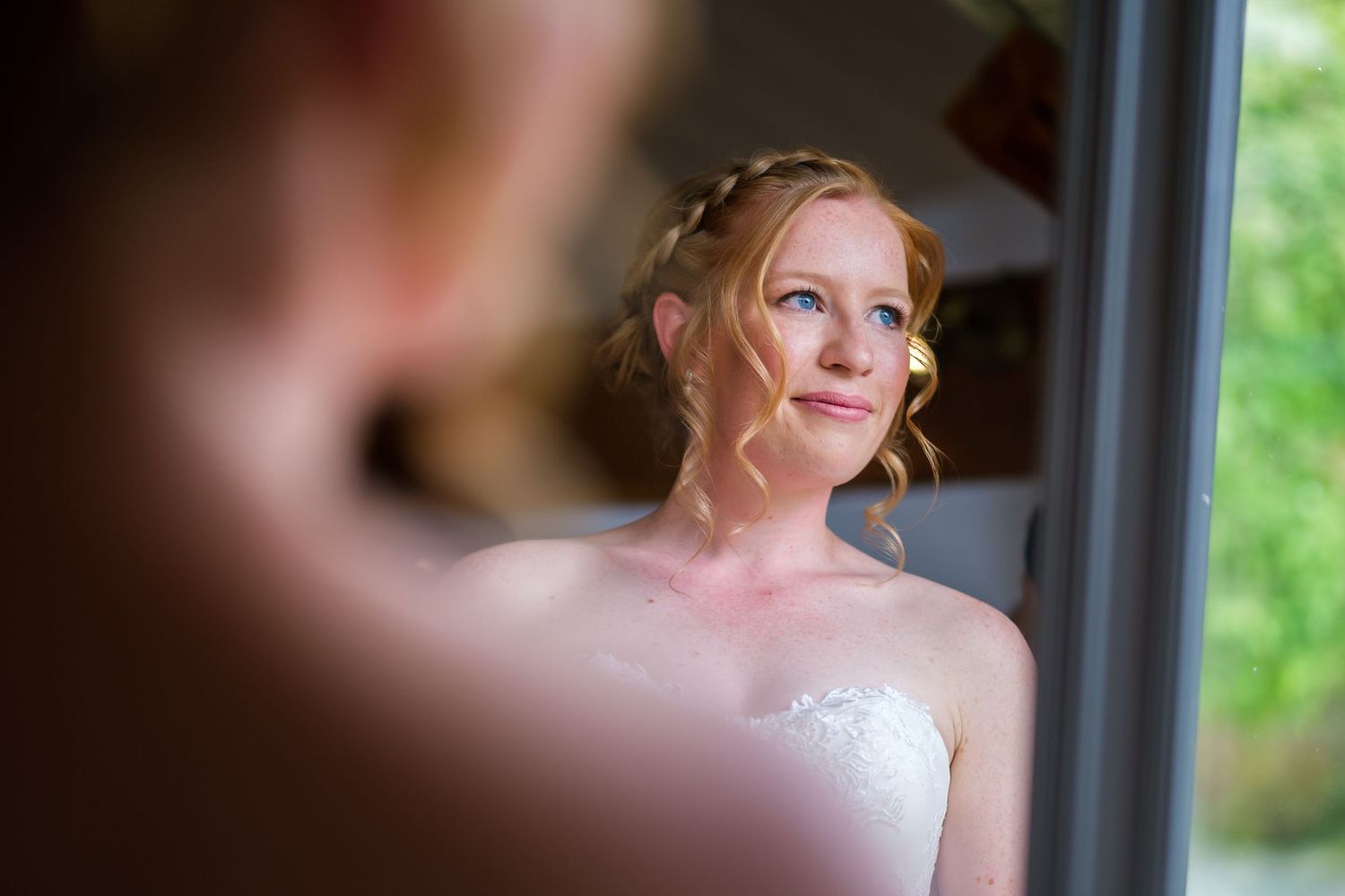 Natural light portraits captured through window reflections in a bridal suite.